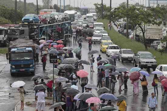 Com a Avenida Brasil interditada pelos alagamentos, muita gente teve que seguir a pé para o trabalho (Bruno Gonzalez/ Agência O Globo) Com a Avenida Brasil interditada pelos alagamentos, muita gente teve que seguir a pé para o trabalho (Bruno Gonzalez/ Agência O Globo)