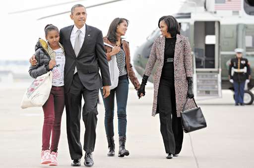 Barack Obama, a mulher, Michelle, e as filhas,  Sasha (E) e Malia (D), ao embarcarem em Chicago para Washington