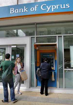 Pessoas fazem fila em caixa eletrônico de uma filial do Banco de Chipre