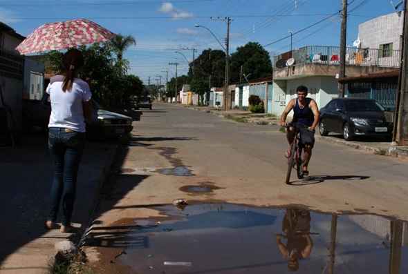 A falha no asfalto existe há dois anos devido à retirada de um quebra-mola. No local, água e esgoto acumulados são foco de mosquitos