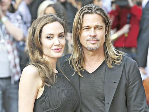 Angelina e o marido, Brad Pitt, na estreia do filme Guerra Mundial Z, em Londres: sorrisos e autógrafos