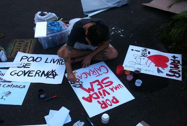 Em frente ao Conic, manifestantes confeccionam cartazes que serão usados mais tarde no protesto