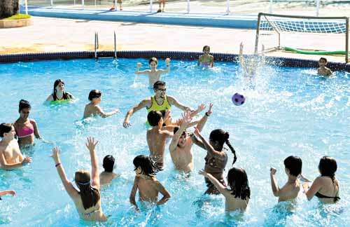 Crianças se divertem em piscina durante colônia de férias: atividades aquáticas são uma das atrações preferidas da garotada