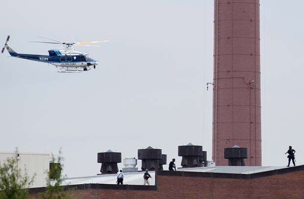 Helicóptero da polícia sobrevoa edifício onde ocorreu um tiroteio na base naval da Marinha em Washington