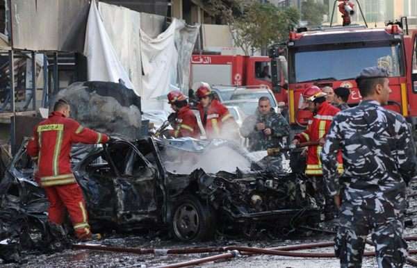 Bombeiros cercam o veículo destruído e carbonizado de Mohamed Chatah (Shatah), o ex-ministro da Fazenda e assessor de ex-premier libanês Saad Hariri, após a explosão de um carro-bomba no centro de Beirute