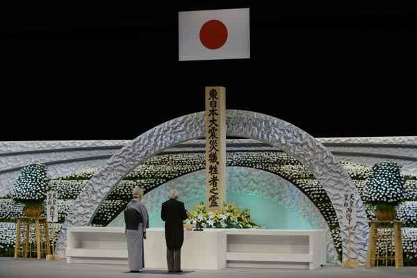 Imperador japonês Akihito (D) e a imperatriz Michiko prestam homenagens às vítimas do terremoto de 11 marco de 2011, em Tóquio