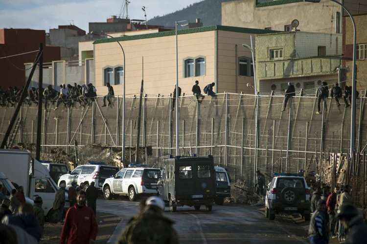 Alguns imigrantes permaneceram sentados na grade após serem descobertos por agentes da guarda civil