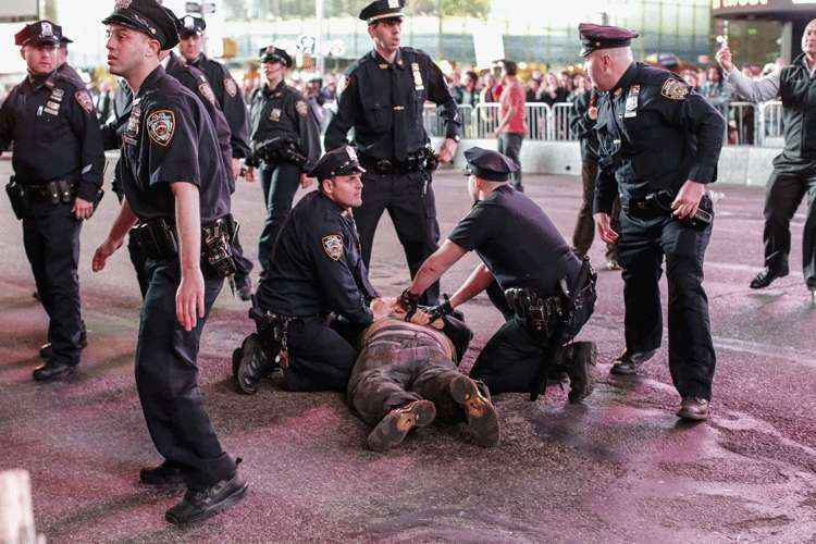 Homem é preso na Times Square, em Nova York, durante os protestos solidários à Baltimore