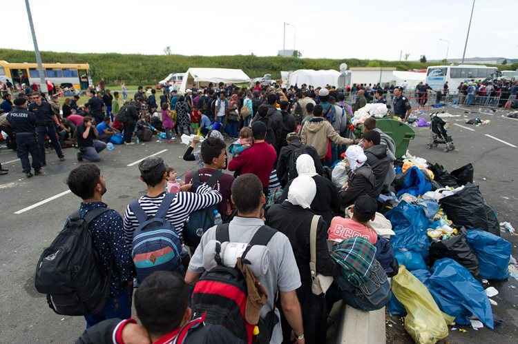 Refugiados esperando para irem até a fronteira da Hungria com a Áustria