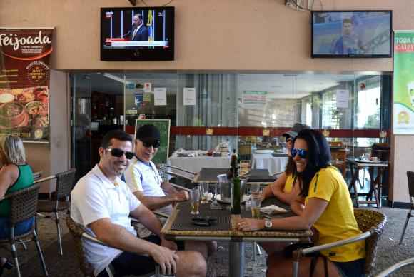 O advogado Tiago Beze e a família acompanham votação do impeachment em um bar