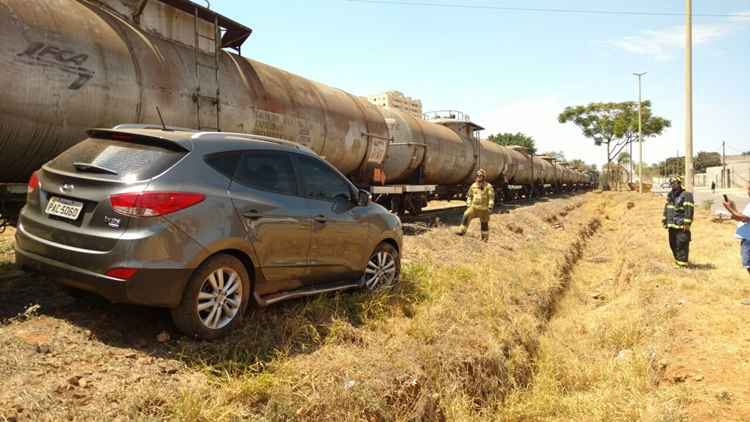 Carro parado ao lado de trem