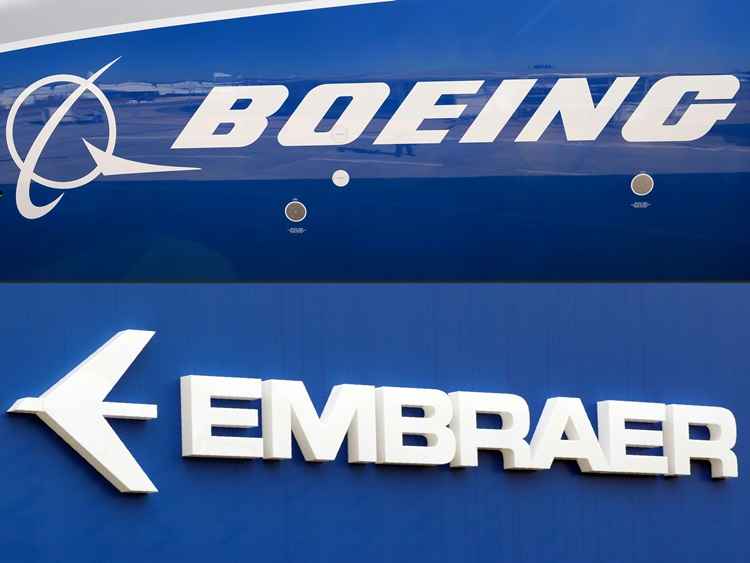 (FILES) (COMBO) This combination of file pictures shows the Boeing logo on the fuselage of a Boeing 787-10 Dreamliner test plane presented on the tarmac of Le Bourget airport near Paris on June 18, 2017, and the logo of Brazil's aircraft manufacturer Embraer also taken at Le Bourget airport, on June 23, 2013. US aerospace giant Boeing and Brazil's Embraer on July 5, 2018 signed an agreement to form a joint venture.Under terms of the deal, Boeing will hold an 80 percent stake while Embraer will hold the remaining 20 percent. / AFP / ERIC PIERMONT