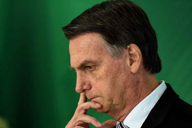 (FILES) In this file photo taken on November 07, 2018 Brazilian president-elect Jair Bolsonaro gestures as he delivers a joint press conference with Brazilian President Michel Temer (out of frame) after a meeting in Brasilia. Brazil's next president, Jair Bolsonaro, takes office on January 1, 2019 with promises to radically change the path taken by Latin America's biggest country by trashing decades of center-left policies. But while the far-right politician enjoys sky-high popularity of 75 percent going into the top job, the challenges to his agenda are formidable. / AFP / EVARISTO SA