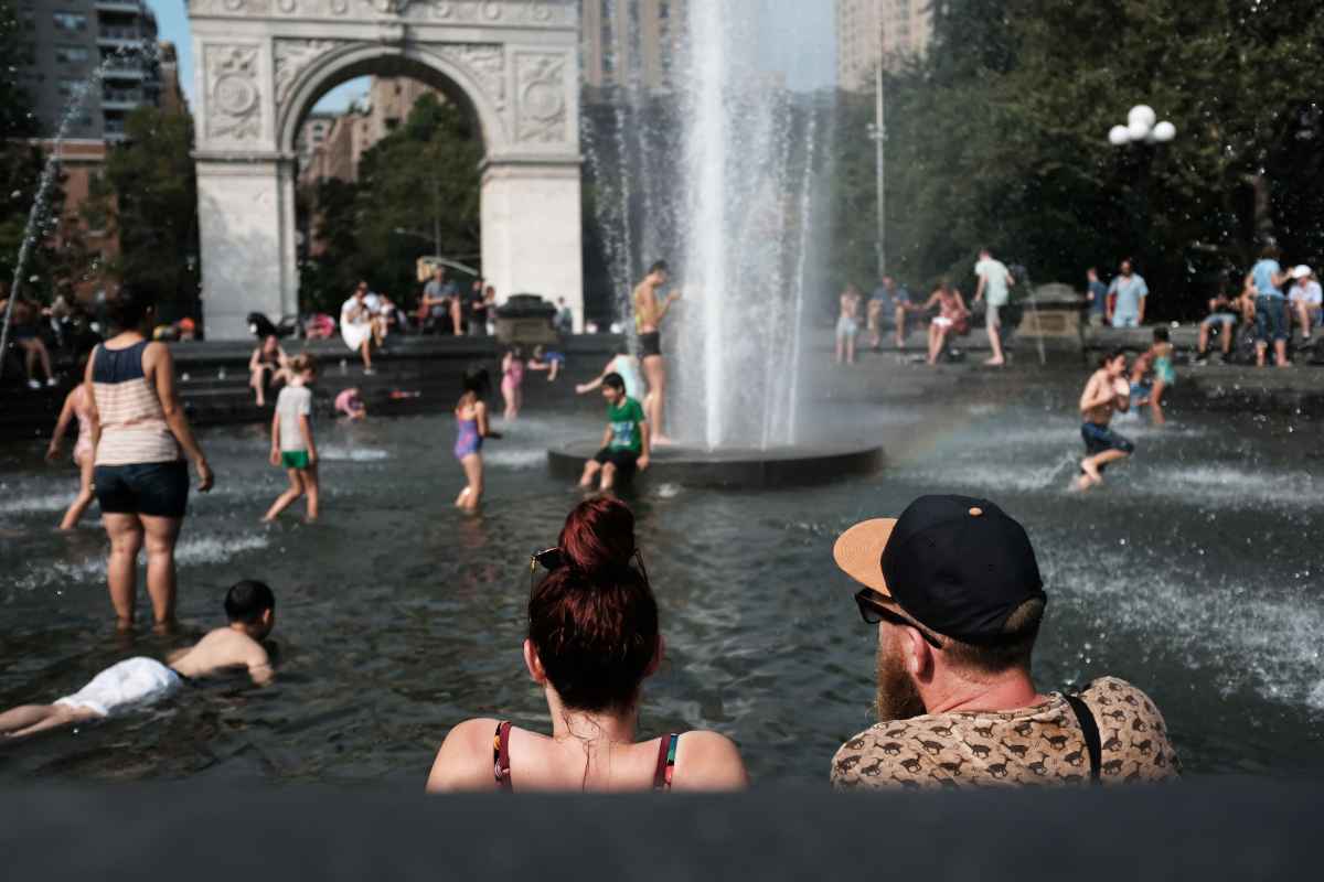 Pessoas se refrescam na fonte da Washington Square Park, no Estados Unidos