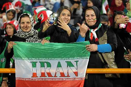 Torcedora de cabelos à mostra na seção feminina do Estádio Azadi 